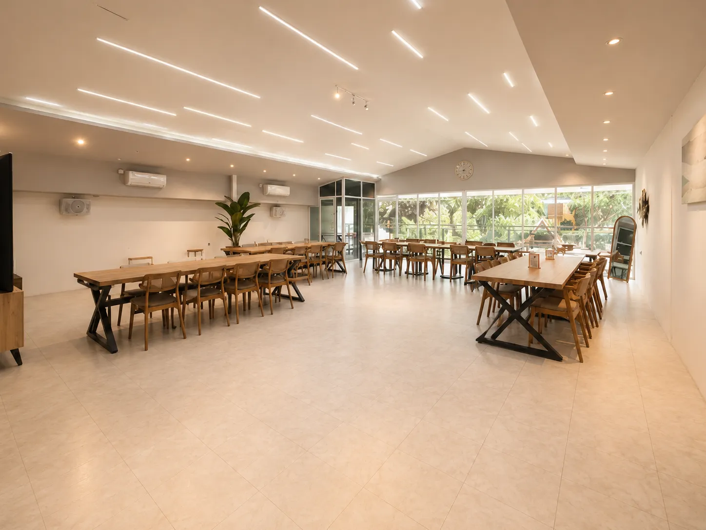 Bake Up meeting room — a bright, spacious space with long wooden tables, comfortable seating, and large windows